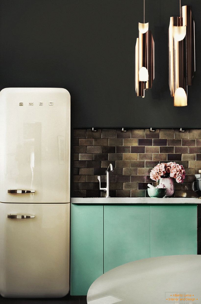 A small kitchen in dark colors and a vintage fridge