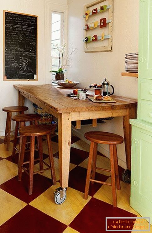 Wooden dining table on wheels