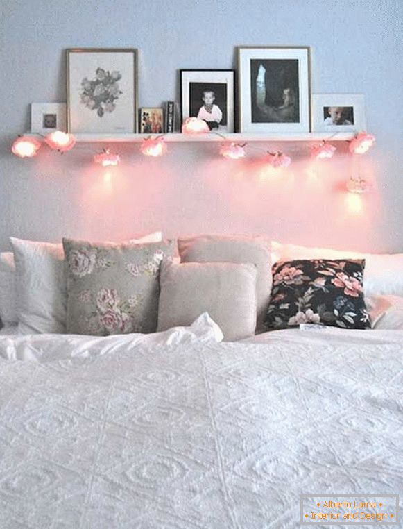 Shelf with creative garland and photo, right above the bed