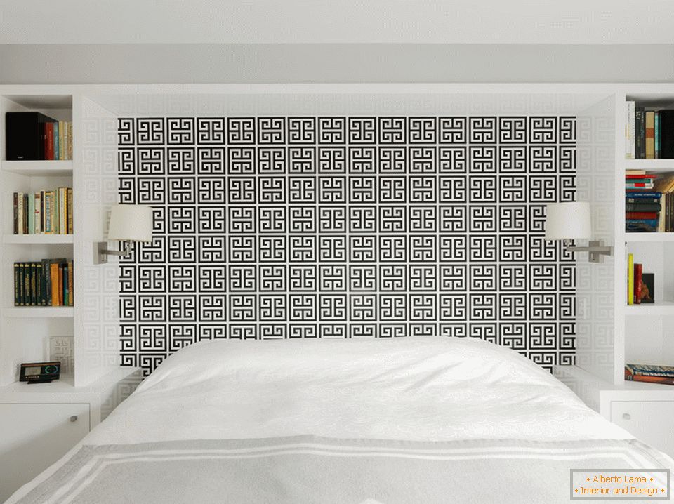 Bedroom in white with a black pattern at the head of the bed