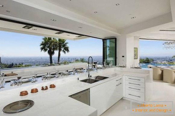Design of a white kitchen with a luxurious view