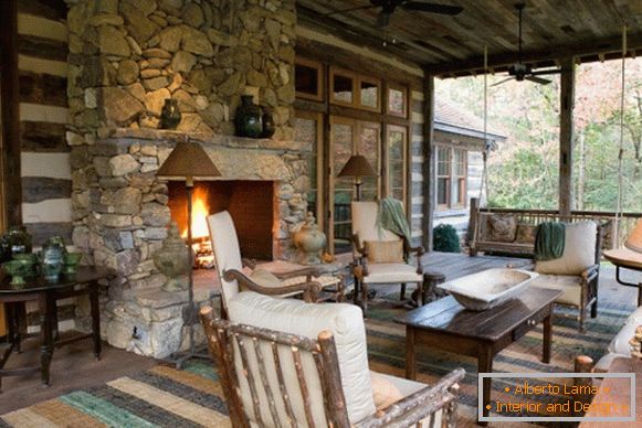 Large rustic veranda with fireplace