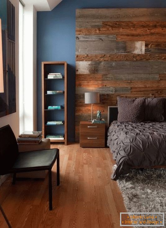 Large wooden headboard and stylish furniture in the bedroom