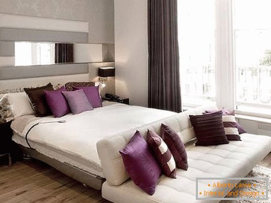 Stylish furniture in the bedroom with purple accents