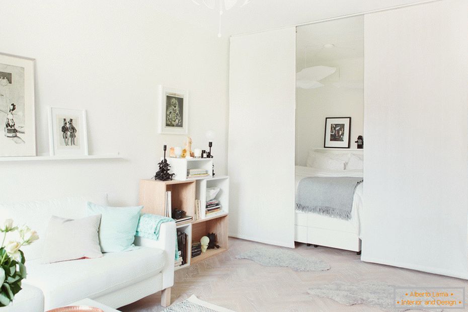 Bedroom behind the partition in a small one-room apartment