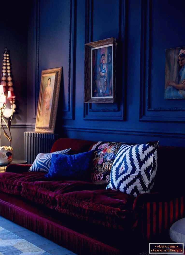 The burgundy sofa on a background of dark blue walls