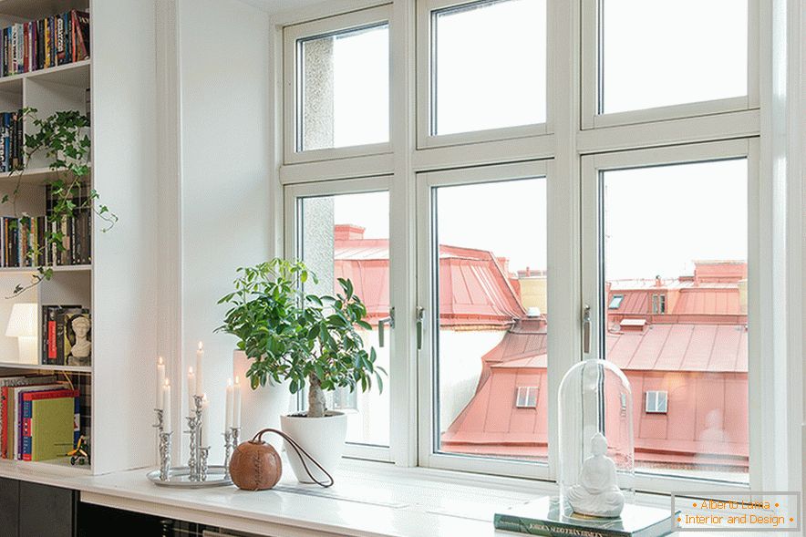 The bookshelf is built into the wall next to the window