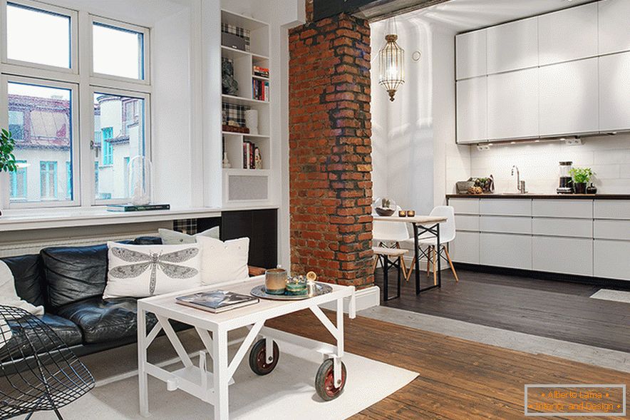 The combination of minimalistic white and brickwork gives the room a unique color.
