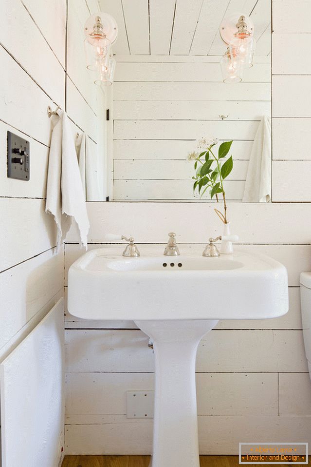 Mirror with built-in sconce over washbasin