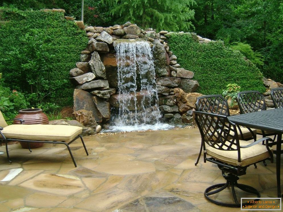 Table and chairs by the waterfall