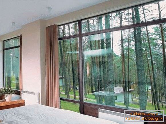 Bedroom with large windows inside a private house