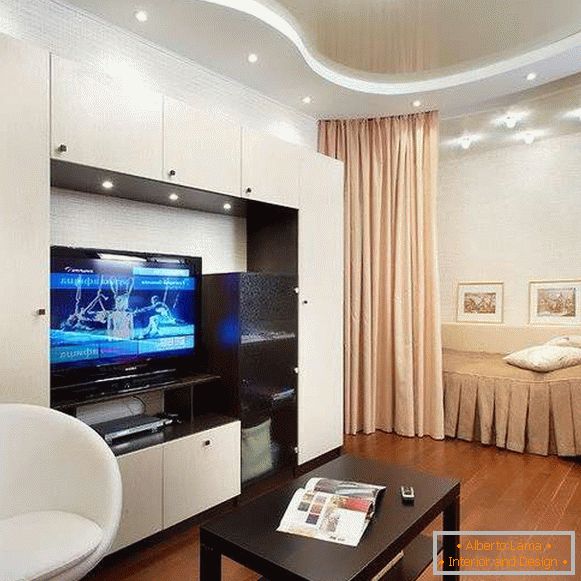Modern interior of a one-room apartment - a bedroom in the living room