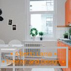 White kitchen with orange furniture