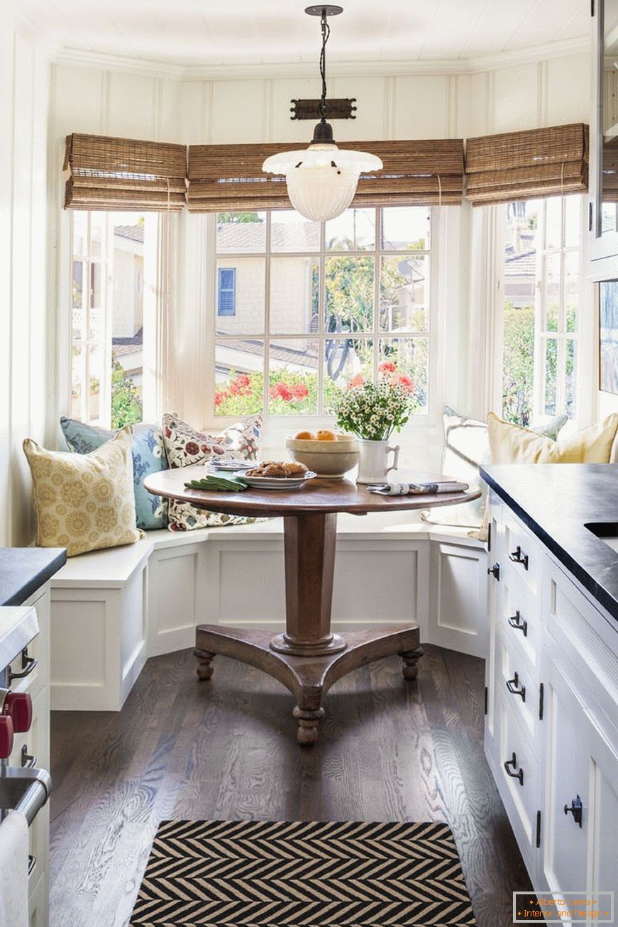 Narrow kitchen with large windows in the bay window