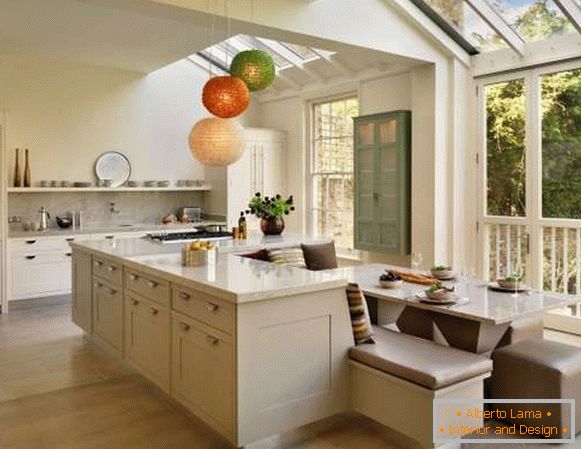 Kitchen design in a private house - photo of a dining area with an island
