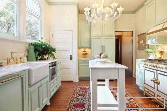 Design of a small kitchen with an island in a private house - interior photo