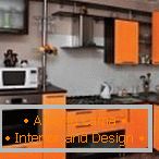 Stylish kitchen in black and orange color
