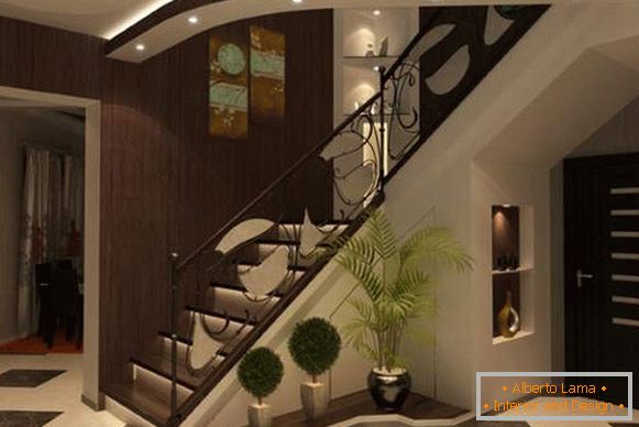 Design of an entrance hall with a staircase in a private house in dark tones
