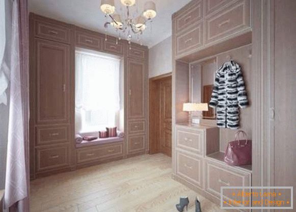 Design of a large hallway in a private house with built-in wardrobes