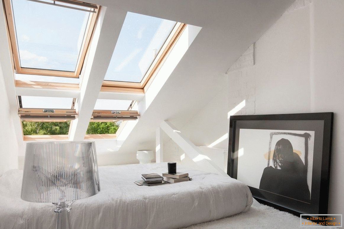 Cozy bedroom with windows on the roof slope