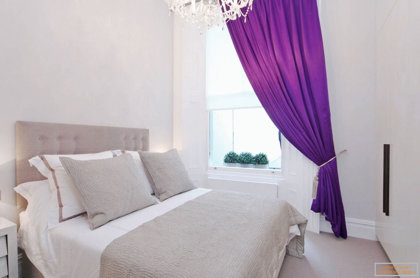 Purple curtains in the white interior of the bedroom