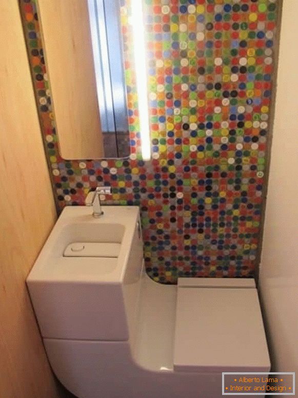 A small toilet with a modern combo toilet and bright mosaic