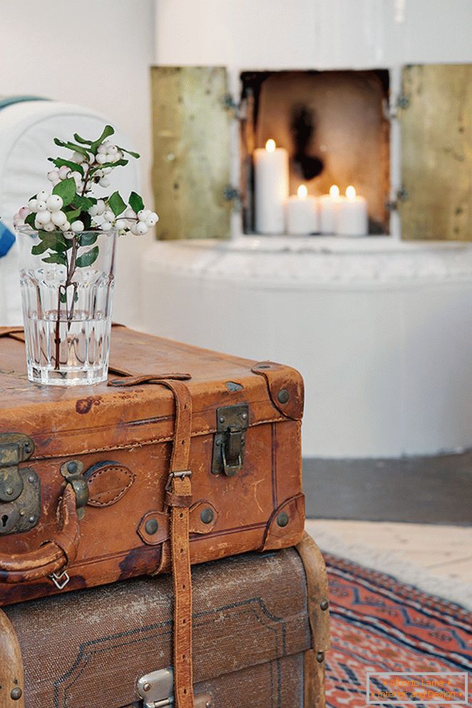 The coffee table is served by two antique suitcases laid on each other