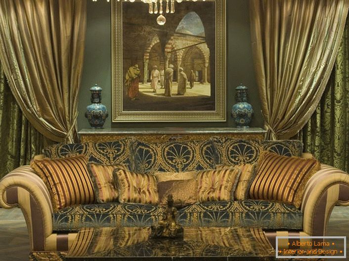 A stylish massive sofa with soft upholstery is decorated with pillows of various sizes in accordance with the style of the baroque.