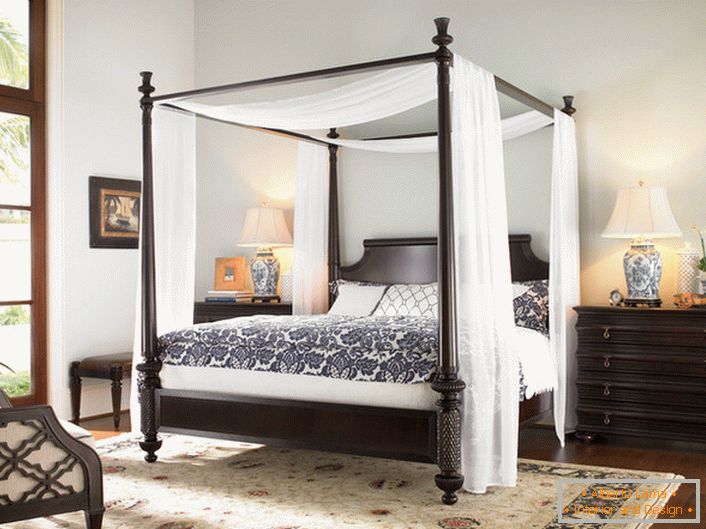 Decorative canopy over the bed in a small bedroom.