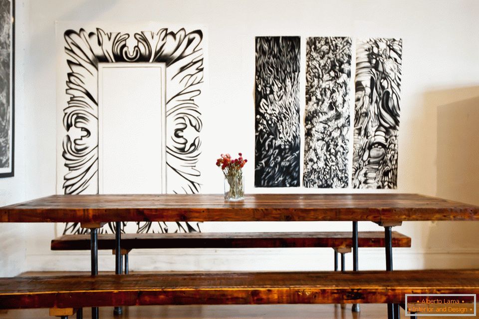 Paintings on the wall in the dining room of a stylish apartment in Brooklyn