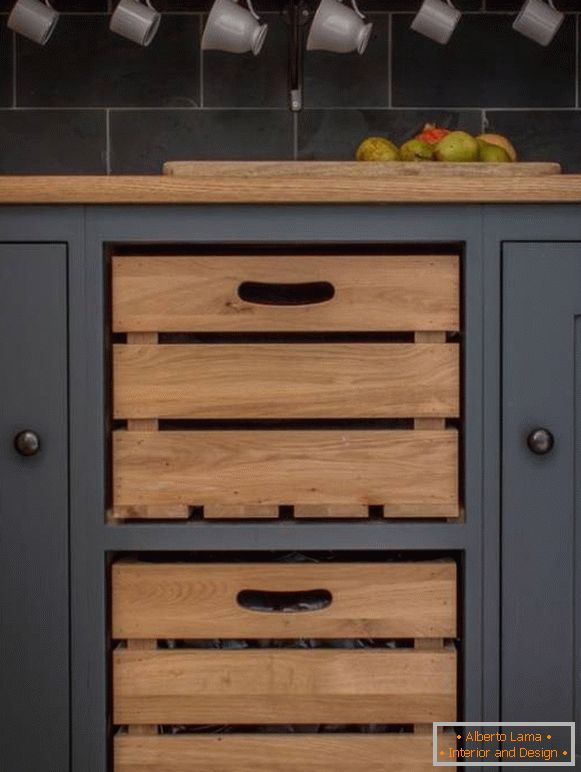 Wooden boxes for vegetables built into the kitchen cupboard