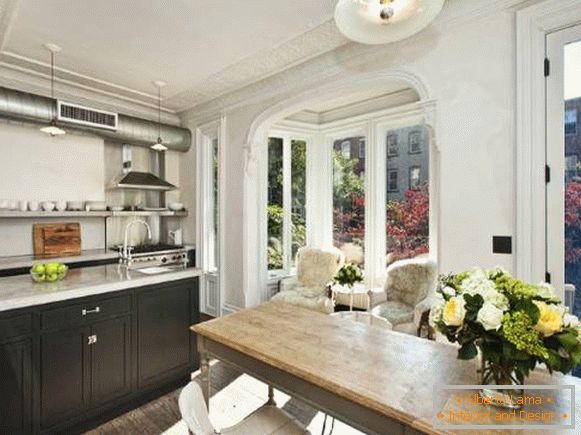 Kitchen design with bay window in the interior of the apartment