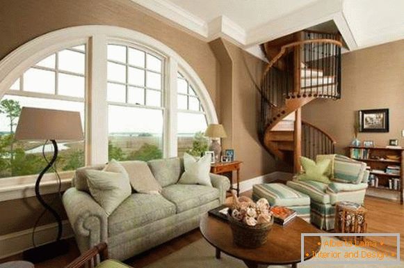 Interior of the living room with a spiral staircase in a private house - design ideas