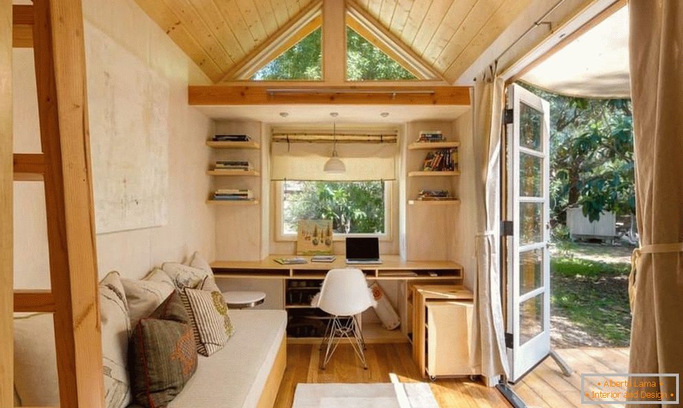 Sofa and table with a computer by the window