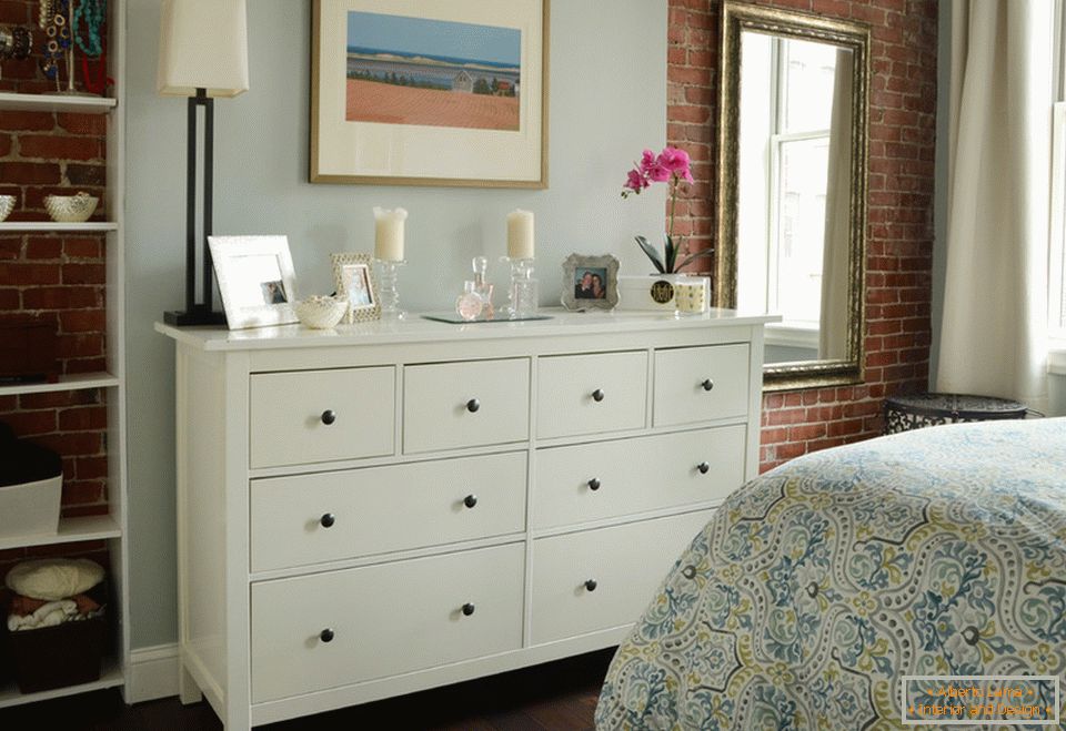 Interior of a small apartment: a chest of drawers in the bedroom