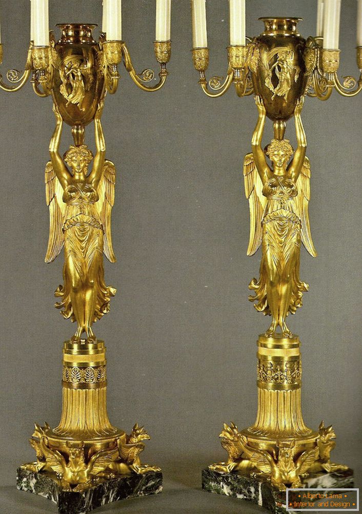 A pair of identical golden candelabra decorate the bedroom in the Baroque style. 