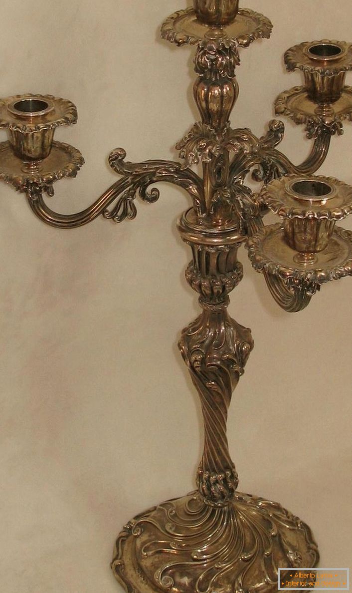 A stylish candelabrum made of copper for four candles for a country lounge.