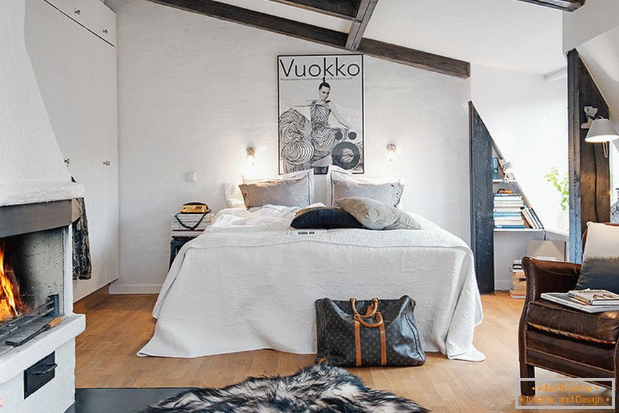 Bed in the interior of a cozy attic in a Swedish city