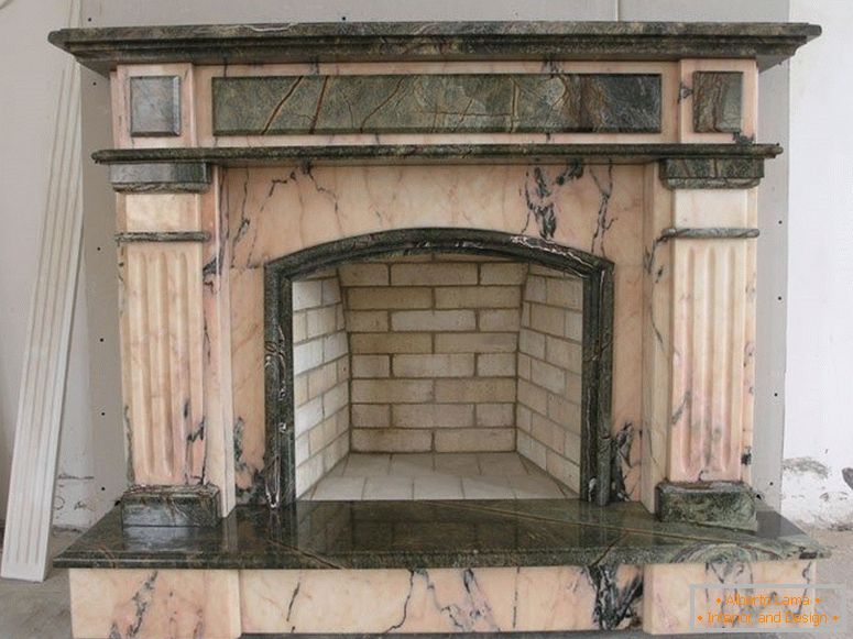 Luxurious fireplace made of bricks, decorated with expensive marble.
