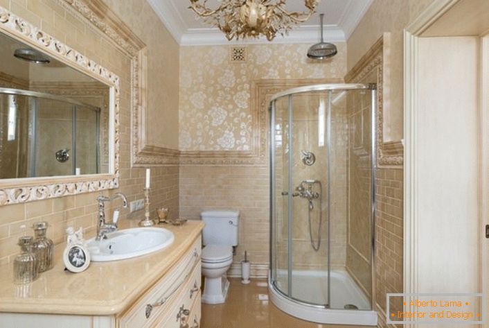 The bathroom is decorated in neoclassic style. A large mirror, framed by a wide frame, makes the picture complete.