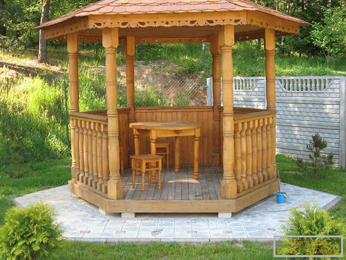 The style of the chalet can also be elegant. Functional solution - a small podium for a gazebo made of granite tiles.