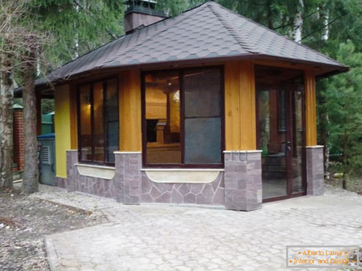 A winter gazebo in the style of a chalet is an ideal solution for designing a suburban area.