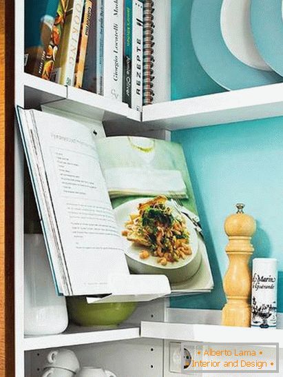 Books and utensils in a small kitchen in turquoise color