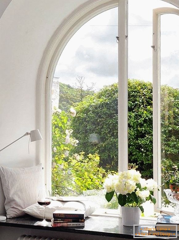 Window decoration with pillows, books, flowers