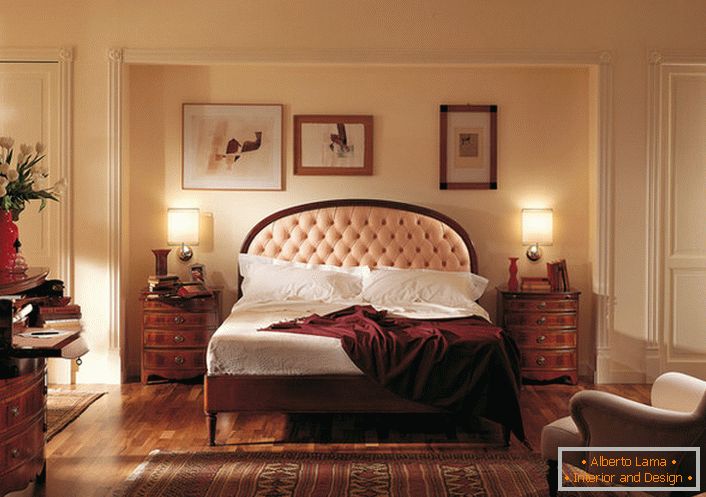 Noble English style in the bedroom is attractive and modest. The center of attention is a bed in a high headboard, which is studded with a soft light beige cloth.
