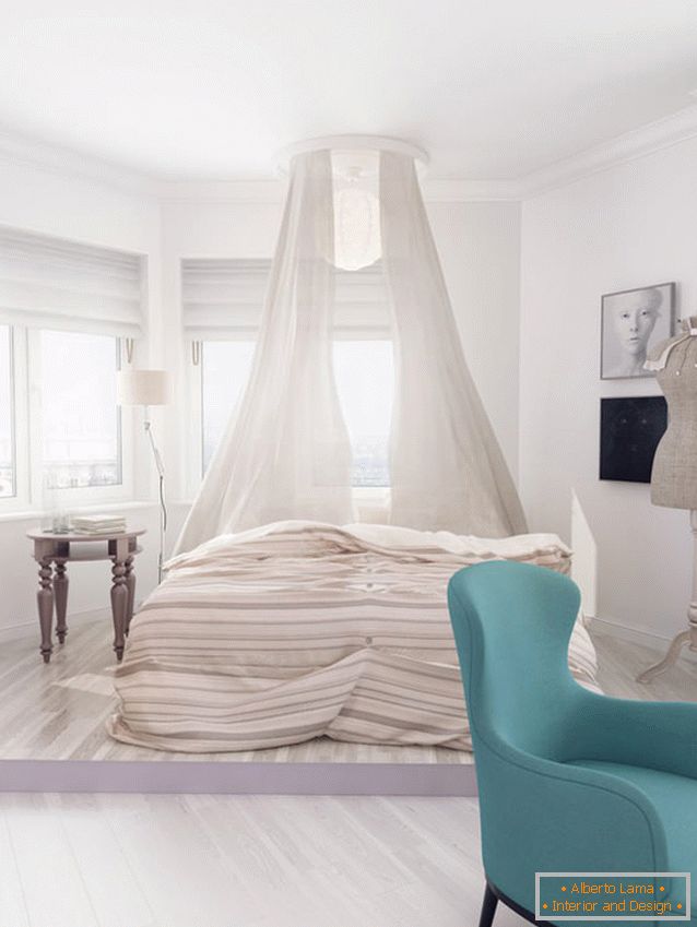 Bed with a canopy in the bedroom of a bright apartment for a girl