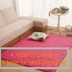 Pink carpet near a white sofa