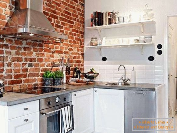 Kitchen design in loft style - photo with red brick wall