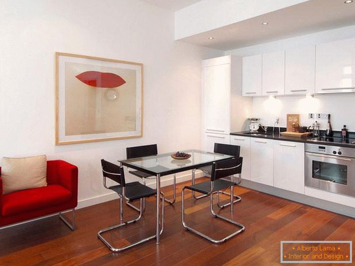 Stylish kitchen with accents of red. Minimalist style is a win-win option for the design of studio apartments. 