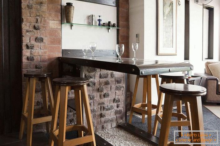 Corner-style loft in the living room. All of the classics of design-old brickwork, a tumbling bar counter.